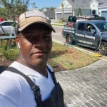 Felipe Abreu, founder of Quality Wash And Seal, during a driveway cleaning project in Florida